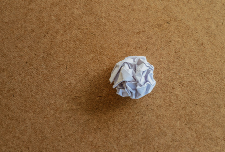 crumpled a piece of paper on woodの写真素材