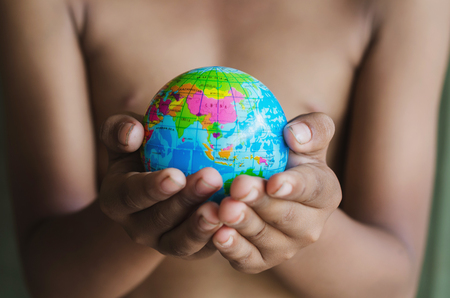 hands hold small globe conceptの写真素材