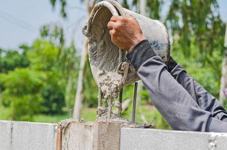 Cement or mortar  by worker cement mixerの写真素材