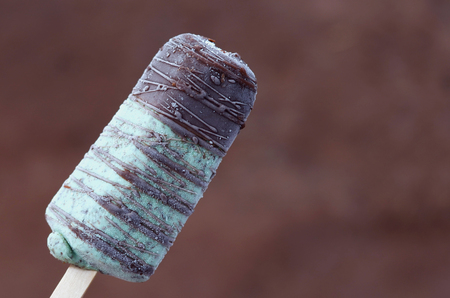 icecream stick on chocolate backgroundの写真素材
