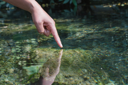 water with hand in pondの写真素材