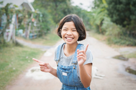 portrait of asian woman smiling hanppy outside at homeの写真素材