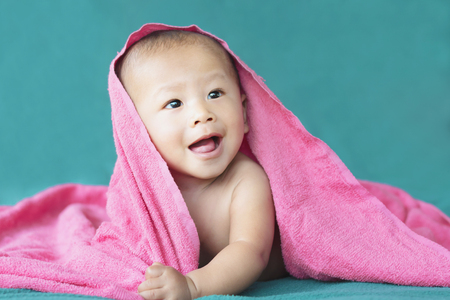 cute asian baby on the bedの写真素材