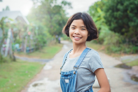 portrait of asian woman smiling hanppy outside at homeの写真素材