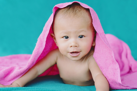 cute asian baby on the bedの写真素材