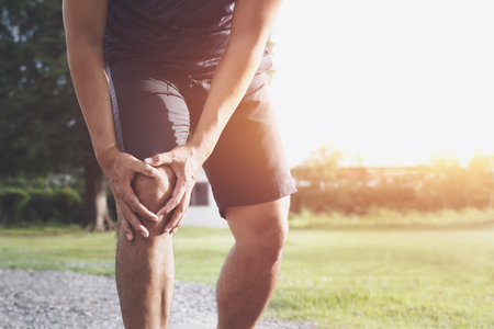 A runner having knee injury at the parkの写真素材