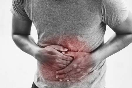 A man having stomach ache isolated on a white backgroundの写真素材
