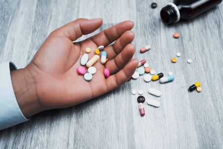 medicine in hand woman on table backgroundの写真素材