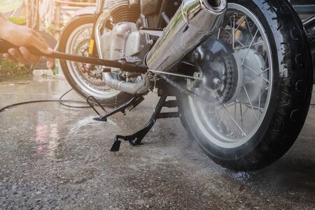 people wash cleaning motorcycle at homeの写真素材