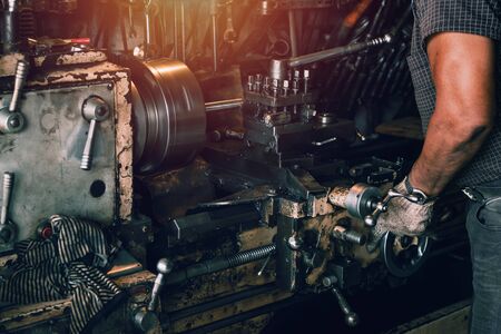 close up worker turning steel in factory