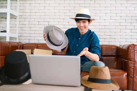seller shows the hat to the customer through a video. Work at homeの写真素材