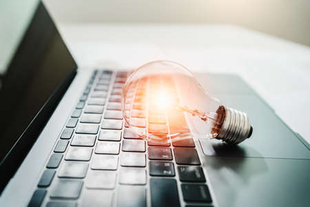 light bulb on laptop computer. power energy conceptの写真素材