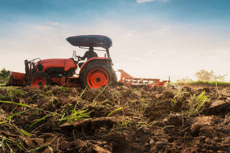Farmer with tractor prepares the land to grow agricultural crops.