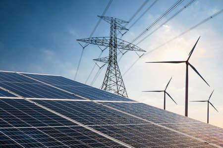electricity power in nature. clean energy concept. solar panel with turbine and tower hight voltageの写真素材