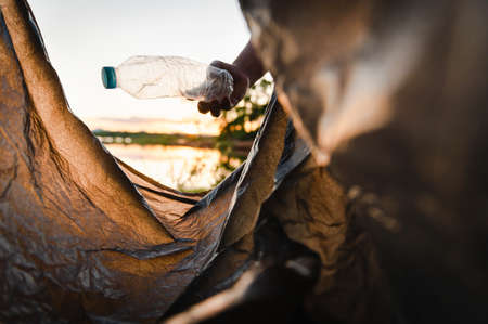 hand picking up garbage plastic bottle for cleaning at parkの写真素材