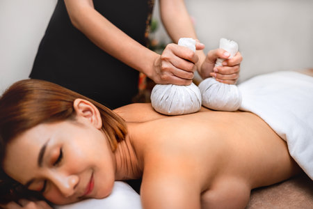Beautiful woman doing Thai massage in spaの写真素材