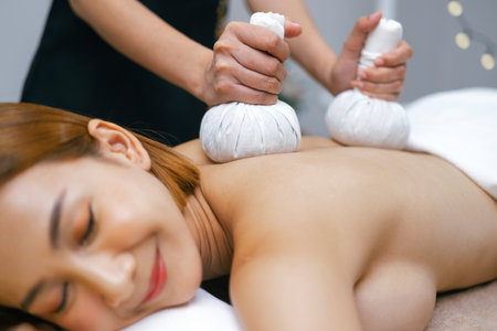 Beautiful woman doing Thai massage in spaの写真素材