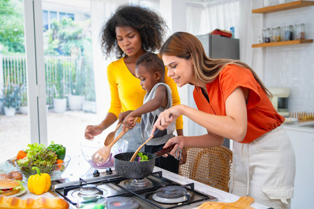 Multiethnic lesbian enjoys cooking in the kitchen. young lgbtq gay woman lover. LGBT lifestyleの写真素材