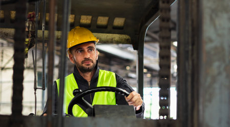 worker wearing helmet with driver forklift in warehouse