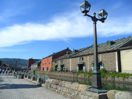 Vintage Street Lamp and the Old Warehouse along Otaru Canal in Japanの写真素材