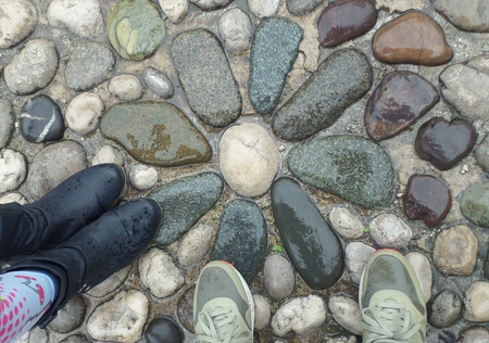 Standing on the Flower Pattern Cobblestone Path in the Light Rain, Mostar, Bosnia and Herzegovinaの写真素材