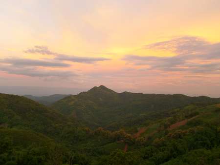 Pastel Yellow and Purple of the after sunset sky over Mountain Range, Highland of Thailandの写真素材