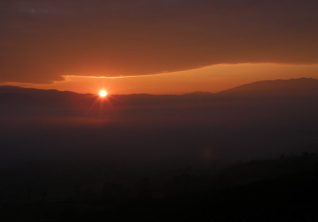Beautiful Sunrise on a Thick Layer of Soft Orange Color Cloudsの写真素材