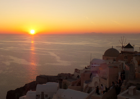 Beautiful Sunset over Aegean Sea at Oia Village, Santorini Island of Greeceの写真素材