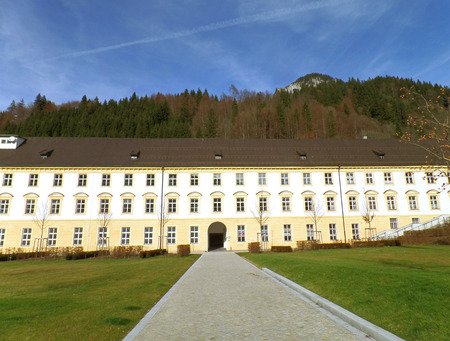 Cobblestone walkway to the Vintage Building of Ettal Abbey in Garmisch-partenkirchen, Bavaria, Germanyの写真素材