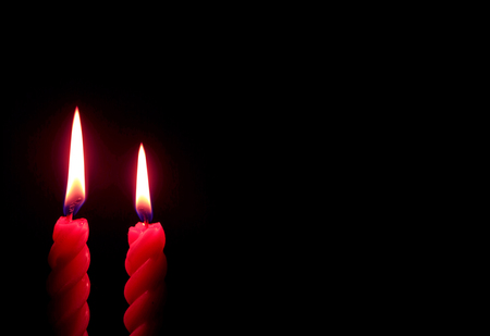 Pair of Burning Red Candles On the Dark Backgroundの写真素材