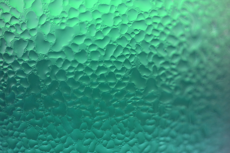 Water drops texture on the light green glass, closed up for abstract background with selective focusの写真素材
