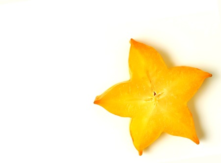 Close-up of orange yellow color sliced ripe Star Fruit on white background, with free space for design and textの写真素材