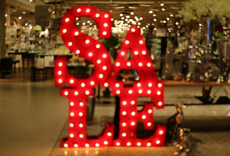 Out of focus light-up SALE sign in front of a shop in shopping mallのeditorial素材
