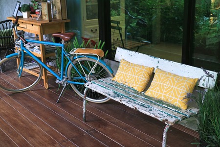 Relaxing space at the terrace with cozy bench and bicycleの写真素材