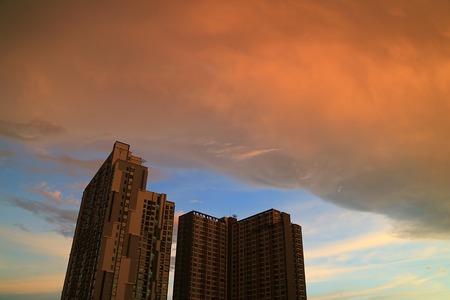 The rain clouds with sunset afterglow reflections scrolling on the building in Bangkok, Thailandのeditorial素材