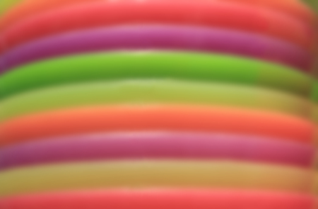 Abstract blurred photo of piled up colorful platesの写真素材