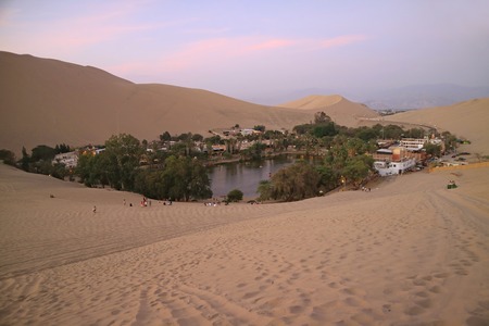 Breathtaking view of Huacachina, the oasis town as seen from the sand dune at sunset, Ica region, Peruのeditorial素材