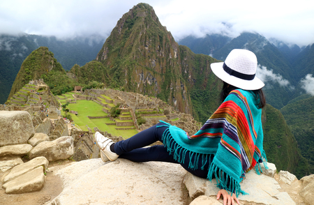 Young female traveler admiring the Inca ruins of Machu Picchu, one of the New Seven Wonder of The World, Cusco Region, Urubamba Province, Peruの写真素材
