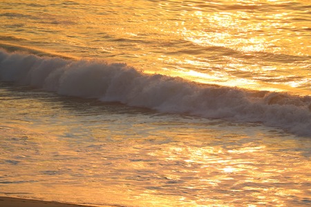 Gold color big waves of Atlantic ocean in the morning sunlight reflections, Rio de Janeiro of Brazilの写真素材