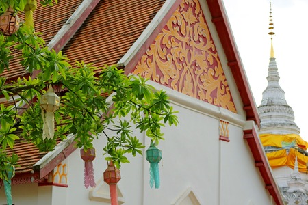 Decorated Tympanum and White Chedi (Stupa) of Wat Phra That Khao Noi Temple, Historic Place in Nan Province, Thailandの写真素材