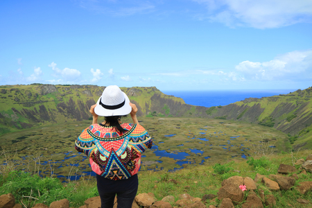 Female Appreciating the Breathtaking View of Rano Kau Crater Lake from Orongo Ceremonial Village on Easter Island with Pacific Ocean in the Distance, Chileの写真素材