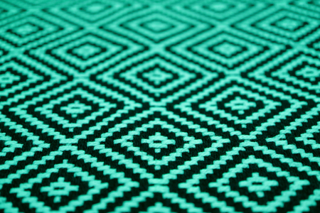Closed up beautiful mint green and black colored ethnic pattern fabricの写真素材