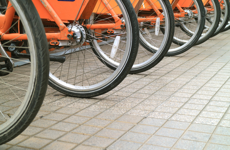 Row of bicycle wheels on the sidewalk of downtown Santiago, Chileの写真素材