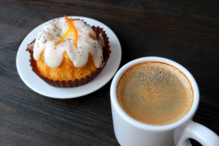 Cup of Hot Coffee with Orange Poppy Seed Yogurt Cake Served on Wooden Tableの写真素材