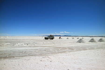 Salt miner extracting salt on Uyuni salt flats or El Salar de Uyuni in Potosi department, Bolivia, South Americaの写真素材