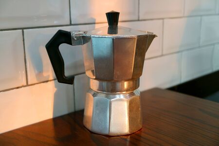 Moka Coffee Pot Isolated on the Kitchen's Wooden Tableの写真素材