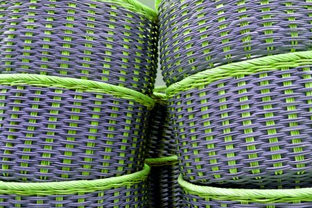Stack of vibrant green and purple colored wicker basketsの写真素材
