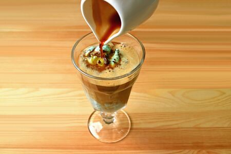 Glass of tasty and aromatic Affogato served on wooden table
