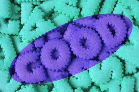 Heap of aqua blue alphabet shaped cookies of the word GOOD in purple coloredの写真素材