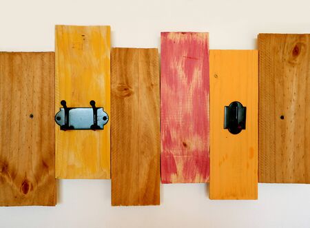 Warm Color Tone Painted Wooden Decorating Panel on the Concrete Wallの写真素材